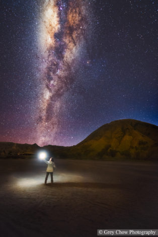 Milky Way photography by Grey Chow - person with light